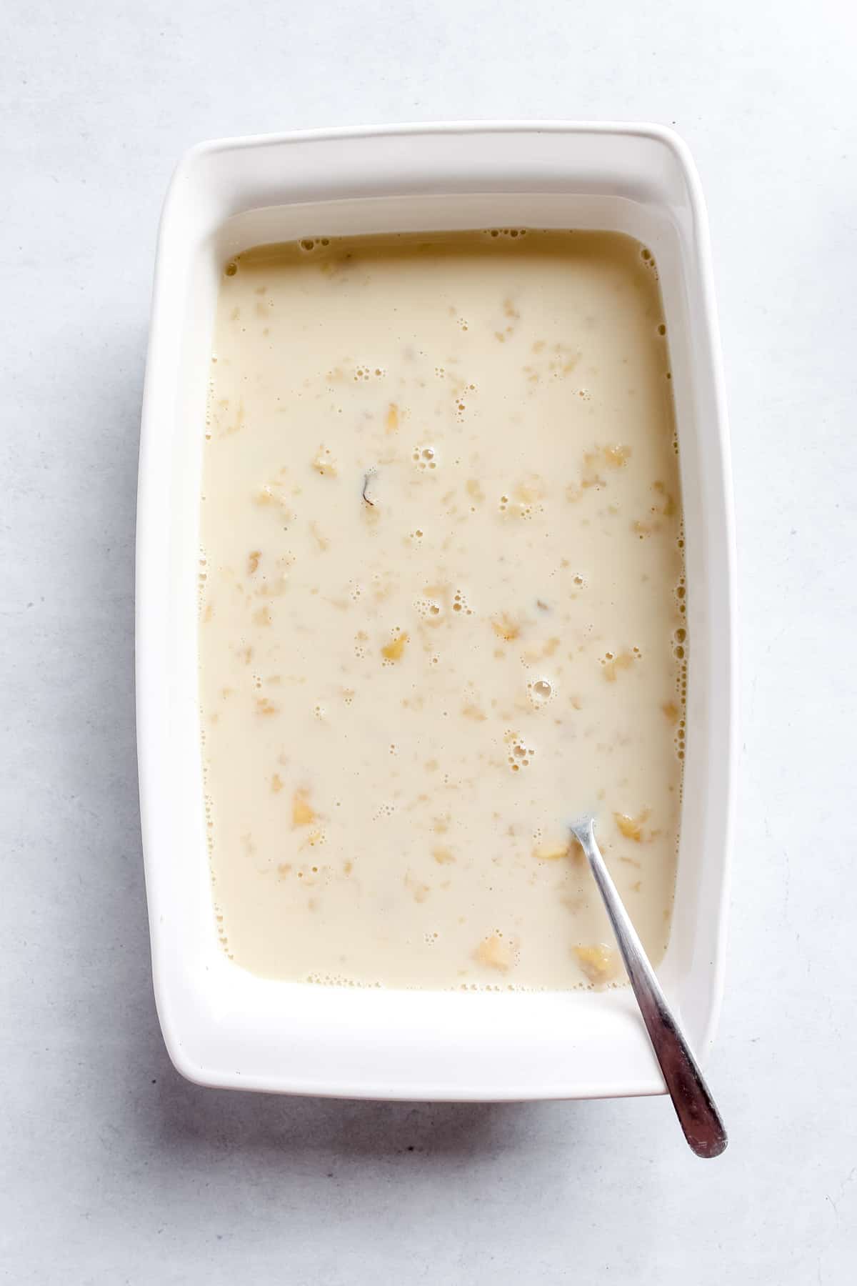 Mashed banana and plant-based milk in white baking dish