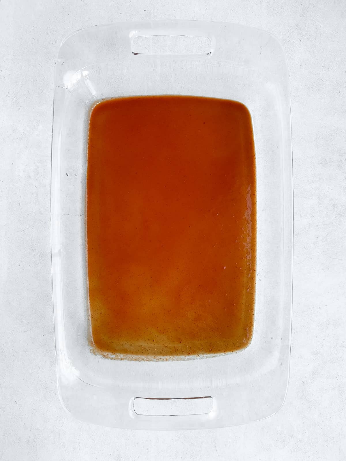 Red enchilada sauce in baking dish