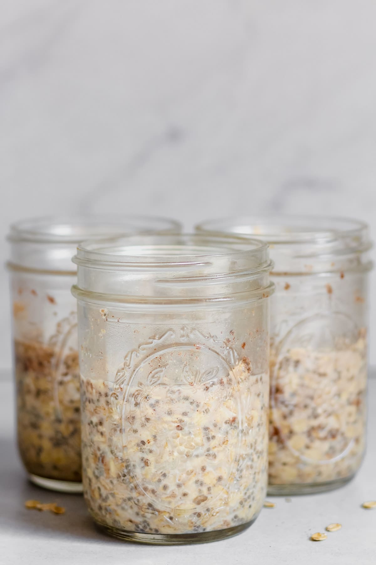 3 mason jars filled with cardamom overnight oats