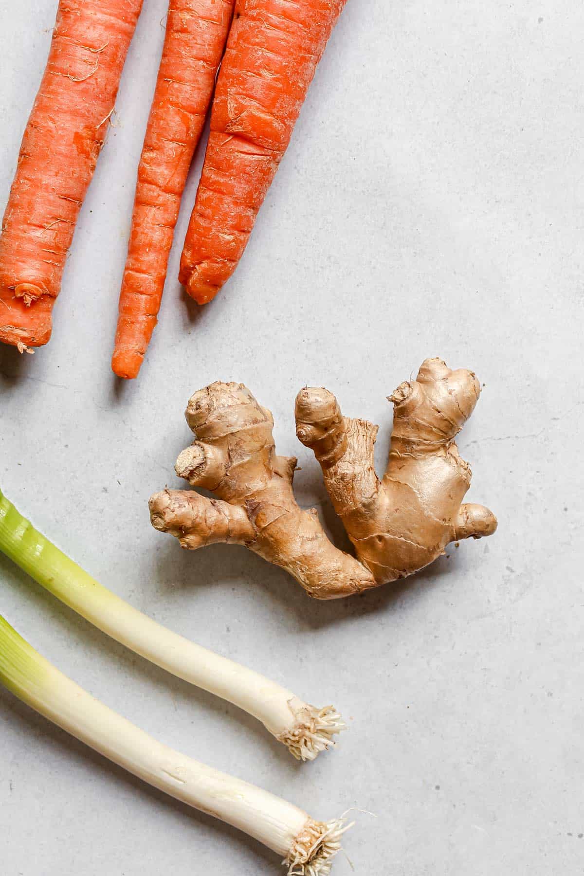 Ginger root, carrots, and green onions