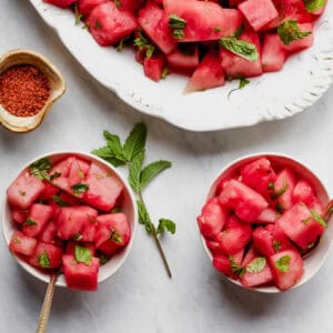 Two bowls full of watermelon with lime and mint