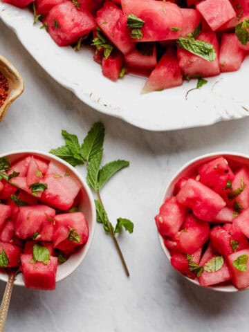 Two bowls full of watermelon with lime and mint