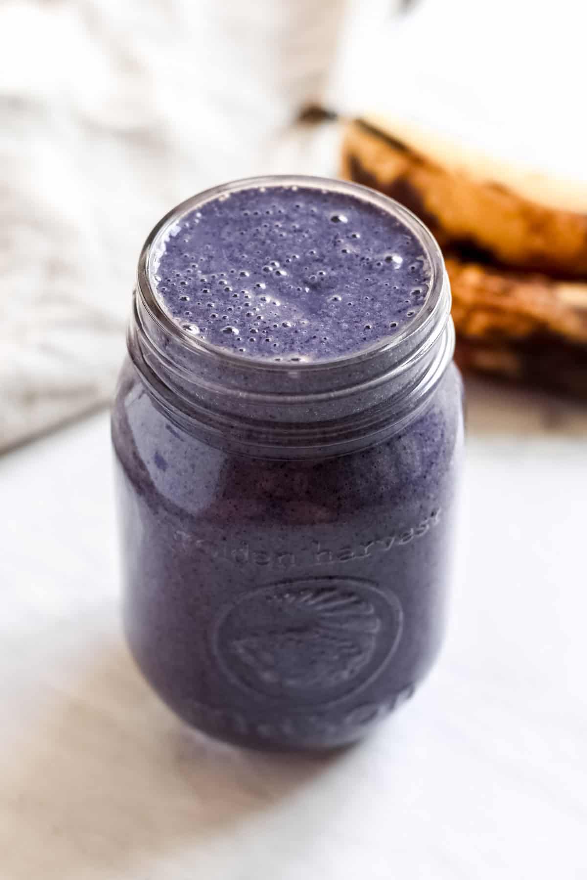 Blueberry Banana Peanut Butter Smoothie served in a mason jar.