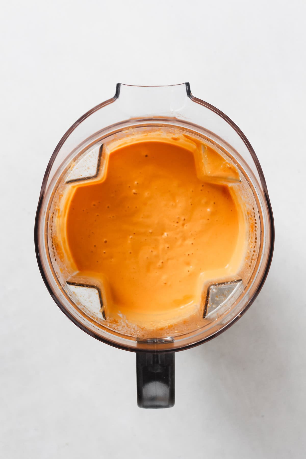 Blended cashews, water and buffalo sauce in blender