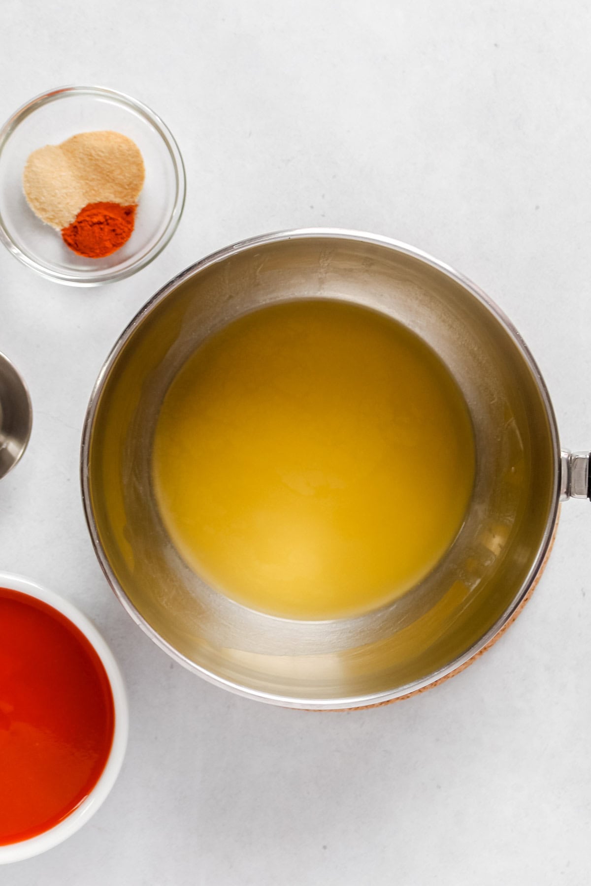 Melting plant-based butter in small stainless steel pan.