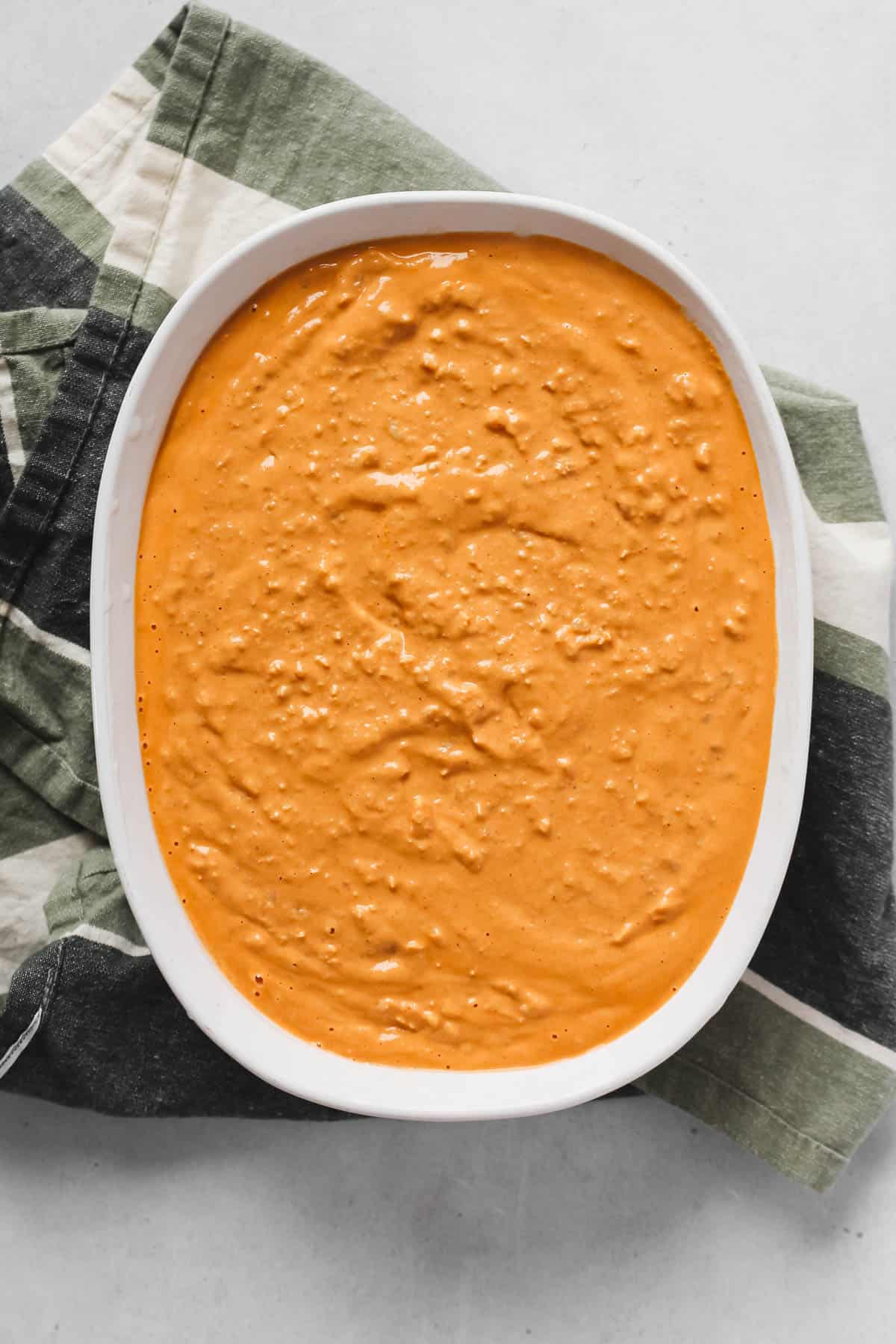 Uncooked Buffalo Chicken Dip in White Baking Dish